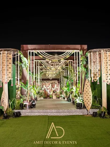 A grand and dramatic entrance for a traditional wedding, featuring an intricate walkway lined with custom-designed leaf motifs and macrame curtains.