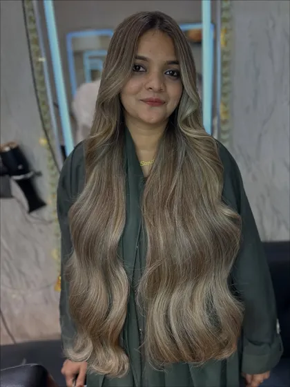The happy client with her new Icy Ash blonde hair. The color brightens her complexion and looks absolutely stunning.