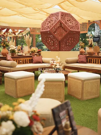 A close-up of the cane poufs and wooden lounge furniture.