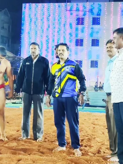 A wrestler stands ready for his bout announcement at the Dangal. The atmosphere is electric.
