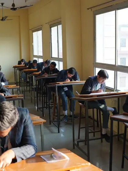 A wide shot of an exam hall with older students, showing that our programs cater to a wide age range.