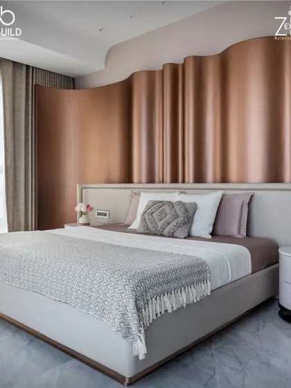 The bedroom in 'The House of Arcs' features a unique, wavy metallic headboard that adds a sense of fluidity and movement to the space.