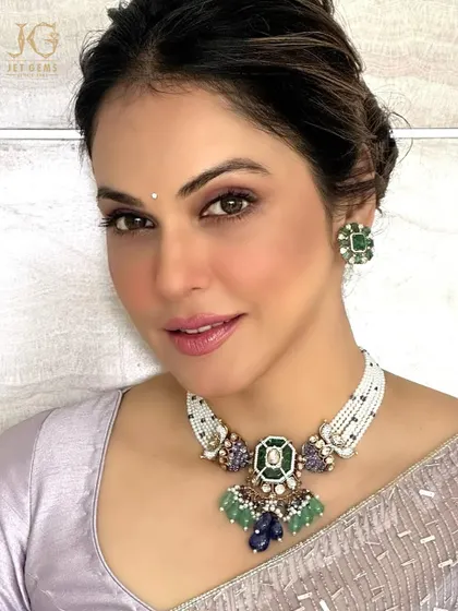 A close-up of our stunning emerald and sapphire necklace, a piece that tells a story of heritage and elegance. The intricate setting and vibrant colours make it a true work of art.