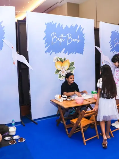A wide view of the different art stations, including pottery, bath bomb making, and stone painting.