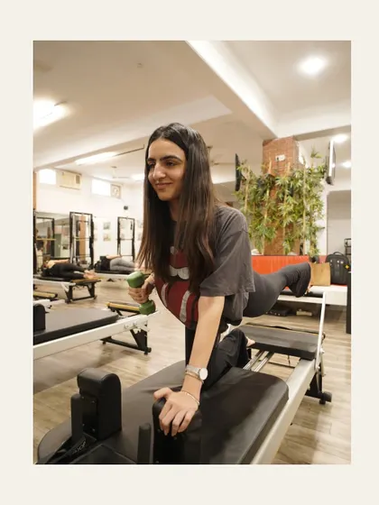 A smile mid-workout says it all. This client is working on balance and glute strength with a dumbbell for extra resistance.