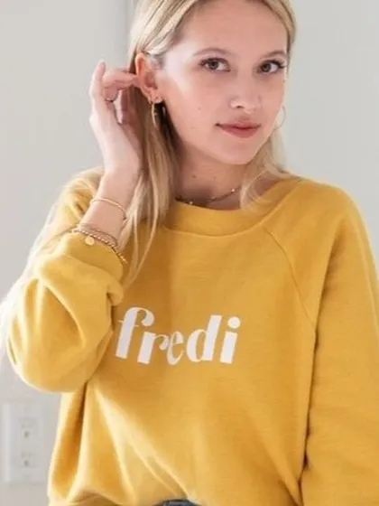 This is a perfect example of lifestyle photography. The model in a casual sweatshirt, captured in a natural, relaxed pose, helps customers connect with the brand's comfortable and effortless vibe.