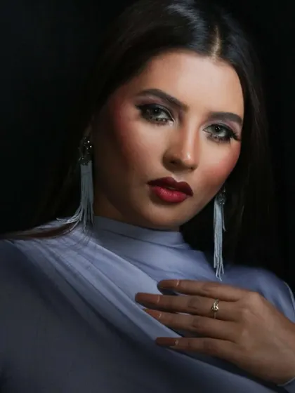 A dramatic pose from the portfolio shoot, highlighting the glamorous makeup.