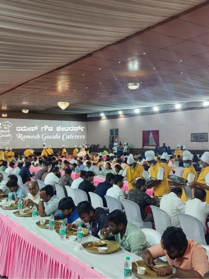 Our staff, identifiable by their uniforms, move efficiently to serve a large number of guests during a reception lunch.