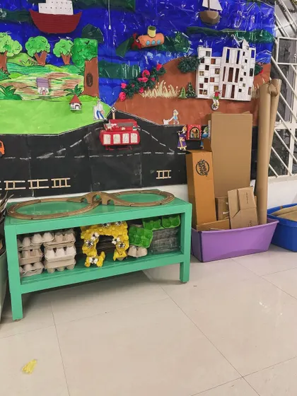 A shelf that once held toys is now filled with egg cartons and cardboard boxes. This setup is an open invitation for children to build, design, and invent, proving that creativity doesn't require new or shiny things.