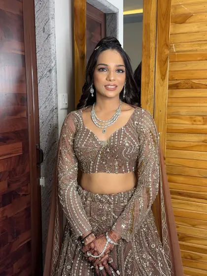 A full-length view of her stunning, shimmery lehenga. The makeup is designed to complement the outfit perfectly.