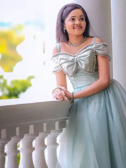 Our client looks like a real-life Cinderella in this glittering powder blue ballgown with an off-shoulder bow detail.