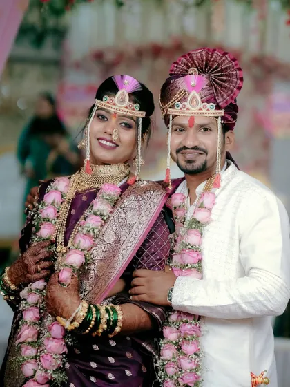 A classic, frame-worthy portrait of the smiling couple, perfect for a Maharashtrian wedding album. We make sure to get those essential shots for the family.