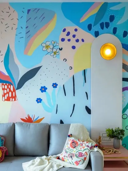 This room is designed to spark instant joy. The vibrant, abstract wall mural by a collaborating artist becomes the stunning centerpiece of this fun and energetic space.