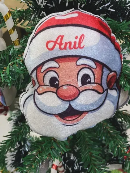 A close-up of our Santa plush ornament, a cheerful addition to any Christmas tree.