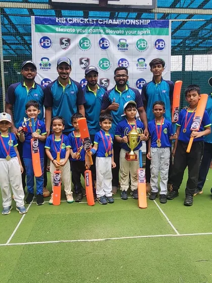 A team of junior champions and their coaches pose with their trophy at the HB Cricket Championship. These tournaments provide a platform for young athletes to test their skills and experience victory.
