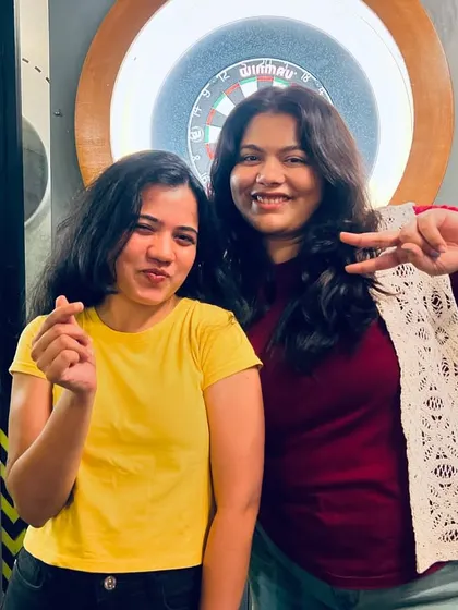 All smiles at the dartboard. Our game nights are a great way to meet new people and challenge them to a friendly game of darts.