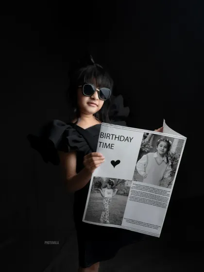 Reading the birthday news! This seventh birthday shoot featured a custom-made newspaper prop, making her feel like a real celebrity on her special day.