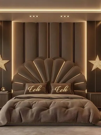 A symmetrical view of the magnificent shell-shaped headboard, flanked by matching bedside tables and star-shaped wall lights. The plush, tufted bedspread adds to the room's five-star hotel feel.