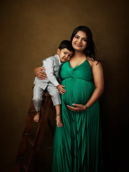 A beautiful maternity portrait with a mother-to-be and her son. His gentle hug around her belly is a sweet preview of the sibling bond to come.