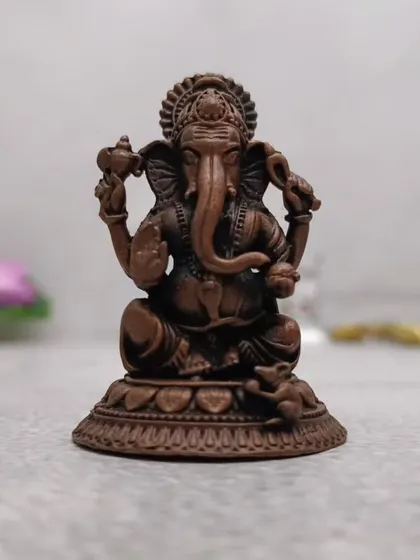 A copper-finish Ganesha idol with beautiful detailing. The antique finish gives it a very classic and revered look.