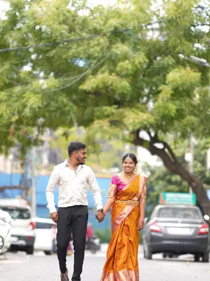 A pre-wedding or post-ceremony shot of the couple walking hand-in-hand down a street. This shows how I can capture beautiful moments in an everyday, urban environment.