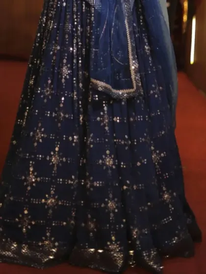 A close-up of the beautiful mirror and sequin work on our navy blue mehendi lehenga.
