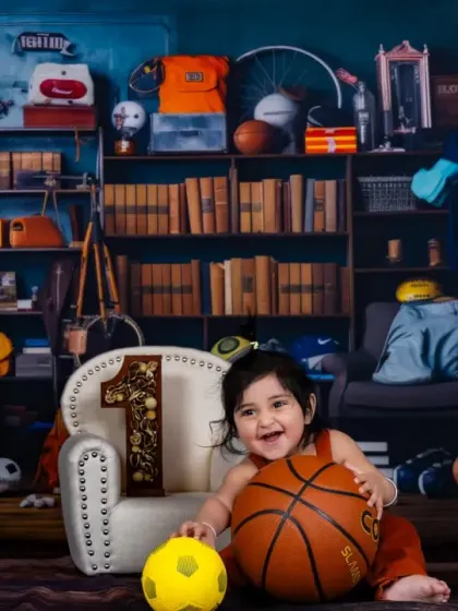 A smile that's a grand slam. Our sports-themed setup is perfect for capturing the energy of active toddlers.