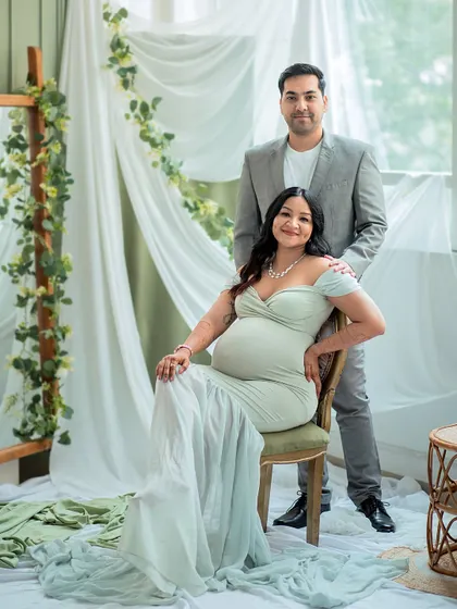 An elegant seated portrait. The flowing fabric of the gown and the classic pose create a look of timeless grace and beauty.