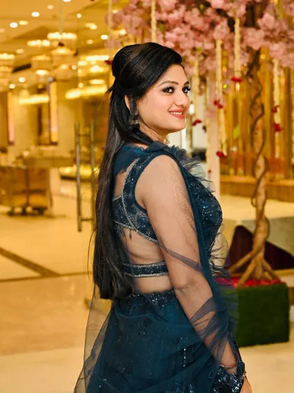 Another angle of the client in the dark blue lehenga, showing off her elegant hairstyle from the back.