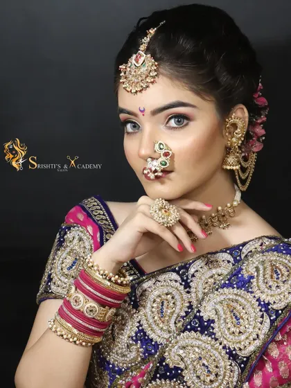 A traditional Maharashtrian bridal look with a modern twist. The makeup is glamorous and defined, with striking eyes and a classic nath.