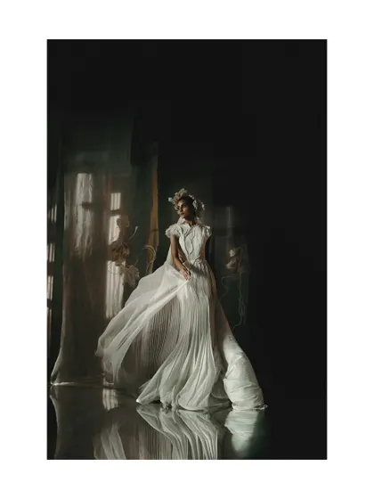 A wide shot from the Vaishali S campaign, establishing the ethereal, dreamlike set design. The flowing white gown and its reflection create a ghostly, beautiful symmetry.