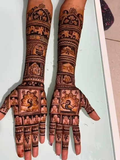 A royal wedding theme with peacocks, elephants, and a Ganesha figure. The intricate details in this full-arm design showcase a variety of traditional wedding symbols.