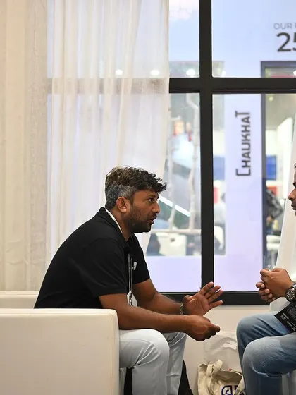 An in-depth conversation happening in the lounge area of our booth. We create comfortable spaces for visitors to sit down and discuss their projects in detail with our experts.