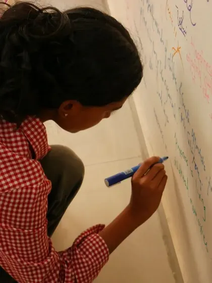 Another volunteer adds her message of hope to our wall.