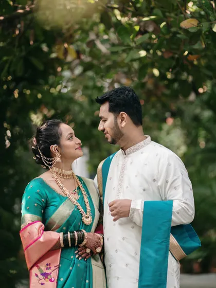 A moment of quiet conversation and connection, with the soft, natural light highlighting the couple's expressions and the rich colors of their outfits.