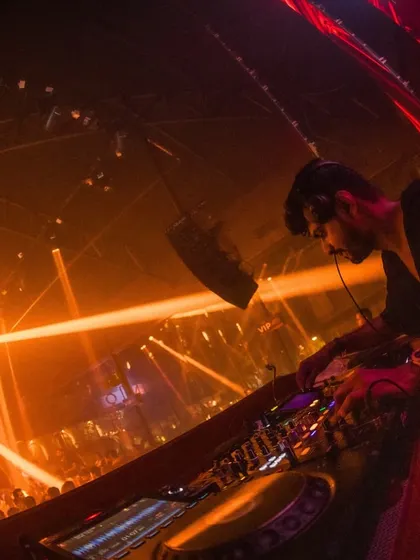My perspective from the DJ booth at Sinq, surrounded by lights and looking out at the massive crowd.