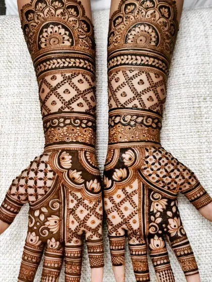 This design showcases my love for intricate jaal, or net patterns. The hands and arms are filled with different styles of check-work, balanced with delicate leafy vines and lotus details.