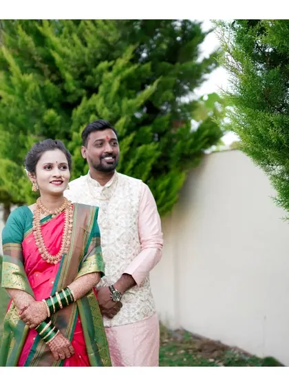 A lovely outdoor portrait of a couple on their engagement day, dressed in elegant traditional outfits.