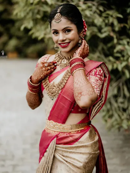 A classic bridal portrait, capturing the bride's elegance and the intricate details of her saree and jewelry.