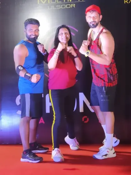 Posing with my mentor and a fellow trainee after my Strong Nation certification. Continuous learning is key, and I'm proud to be part of this powerful fitness community.
