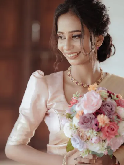 A duplicate of the bride's joyful smile is the centerpiece of this beautiful portrait, her colorful bouquet adding a lovely touch.