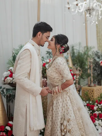 An intimate moment just before a kiss, set against a backdrop of beautiful floral decor.