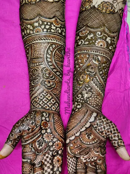 An intricate design that combines floral elements with paisleys and geometric checks. The patterns flow beautifully from the fingers to the forearms, creating a cohesive and elegant look.
