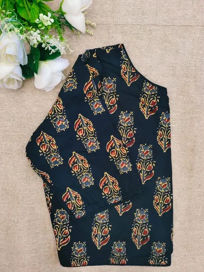 A black cotton boatneck blouse with a classic floral bootidar print.