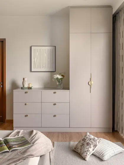 This custom wardrobe and chest of drawers in a muted taupe finish showcases my approach to bespoke storage. The clean lines and elegant brass hardware provide a look that is both modern and timeless.
