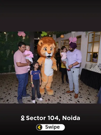Families posing with the lion mascot. It's a popular photo opportunity for guests of all ages.