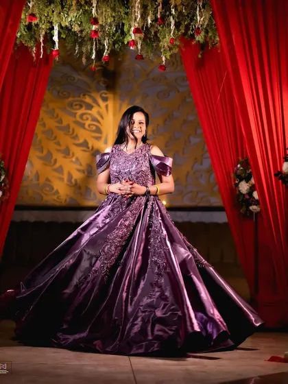 The bride-to-be looking radiant and happy, perfectly captured in her elaborate purple gown.