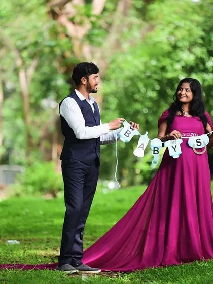 A sweet "Baby Shower" banner adds a celebratory feel to this maternity shoot. The couple looks picture-perfect in their coordinated outfits.