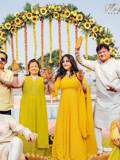 A family portrait from a Haldi ceremony, set against a beautiful circular arch of sunflowers. It's moments like these that I aim to create the perfect backdrop for.