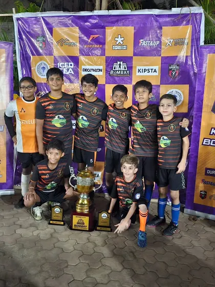 The U13 champions posing with their trophy at the Bombay Football Championship.